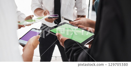 Hands, green screen and technology with a business team in studio isolated on a white background for communication or networking. Tablet, phone and mockup with an employee group on blank space Hands, green screen and technology with a business team in studio isolated on a white background for communication or networking. Tablet, phone and mockup with an employee group on blank space 129705380