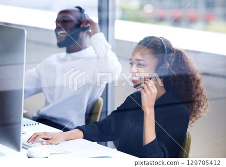 Call center, funny and employees laughing on a computer for consulting, telemarketing and customer support. Comic, contact us and happy customer service agents working in technical support on a pc 129705412