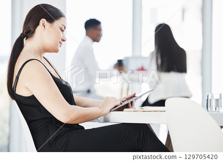 Woman, corporate office and tablet for reading, planning or schedule at desk with business people. Young executive, mobile touchscreen tech and relax on break with social network, web video or ebook Woman, corporate office and tablet for reading, planning or schedule at desk with business people. Young executive, mobile touchscreen tech and relax on break with social network, web video or ebook 129705420