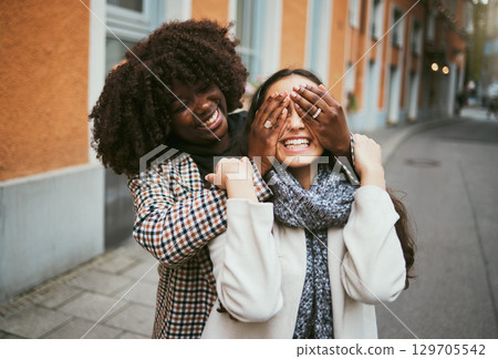 Women, bonding or hands covering eyes in hide and seek, playful or comic game in New York City, road or street. Smile, happy or fun friends and surprise hand gesture in travel freedom or wow birthday Women, bonding or hands covering eyes in hide and seek, playful or comic game in New York City, road or street. Smile, happy or fun friends and surprise hand gesture in travel freedom or wow birthday 129705542