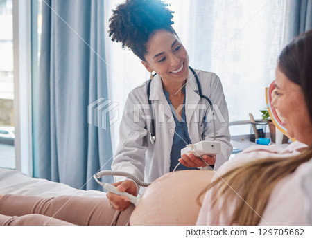 Woman, pregnancy and doctor, ultrasound at clinic with happiness, excited and family planning for future. Black woman medic, pregnant woman and consulting with medical tech on stomach for sonogram 129705682