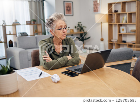 Senior woman, online debt and computer of an elderly person planning retirement savings. Digital budget, paperwork and laptop of an old female reading financial, banking and insurance data or bills 129705685
