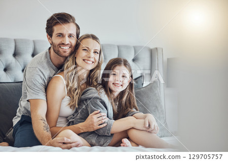 Portrait, mother or father hugging a girl to relax as a happy family in bedroom bonding in Australia with love or care. Morning, embracing or parents smile with kid enjoying quality time on holiday Portrait, mother or father hugging a girl to relax as a happy family in bedroom bonding in Australia with love or care. Morning, embracing or parents smile with kid enjoying quality time on holiday 129705757