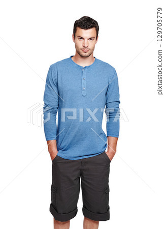 Man, studio portrait and casual fashion with serious face, style and focus by white background. Young isolated model, shorts and clothes with calm, relax or handsome with cool confidence in lifestyle 129705779