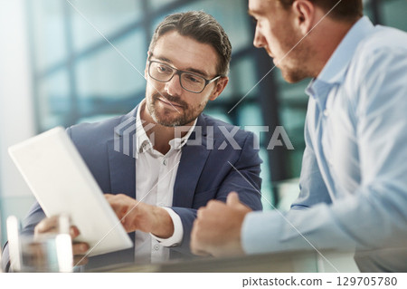 Tablet, teamwork and meeting of business people in office discussion. Collaboration, technology and men or employees with touchscreen planning sales, marketing or advertising strategy in company. Tablet, teamwork and meeting of business people in office discussion. Collaboration, technology and men or employees with touchscreen planning sales, marketing or advertising strategy in company. 129705780