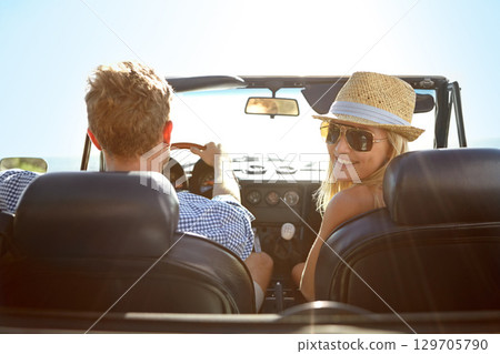 Car travel, road trip and back portrait of couple on bonding holiday adventure, transportation journey or fun summer vacation. Love flare, convertible vehicle or driver driving in Ukraine countryside 129705790