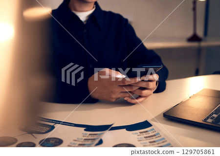 Hands, business woman and phone in office for texting, web browsing or social media. Technology, cellphone and female employee with mobile smartphone for networking or internet scrolling at night. 129705861