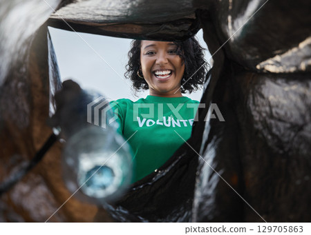 Recycle, smile and woman with view in bag, sustainability and cleaning plastic pollution for earth day and community service. Saving the environment, charity and people putting trash in garbage. 129705863