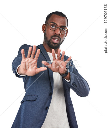 Shock, stop and portrait of a black man in a studio with a scared, fear and terrified face expression. Upset, mad and African male model with a defensive hand gesture isolated by a white background. 129706188