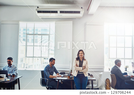 Woman, leader and office portrait with business people, confident smile or arms crossed for success. Manager, leadership and happy for corporate staff, teamwork or group for goal, vision or marketing 129706244