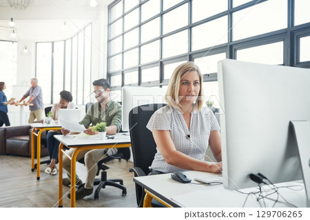 Business, office building and woman with computer working on online email, website research and project. Productivity, corporate agency and female worker at desk for planning, schedule and strategy 129706265