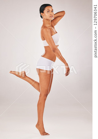 Portrait, body and balance with a model black woman in studio on a gray background for natural beauty. Fitness, wellness and underwear with an attractive young female posing to promote health 129706341