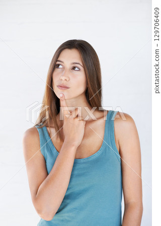Hand, thinking and woman with idea in studio for vision or decision against white background space. Ideas, choice and girl planning, pensive and thoughtful while standing, contemplating and isolated 129706409