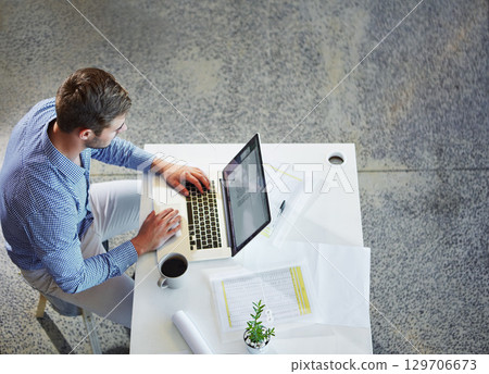 Top view, business and man with laptop, typing and planning for schedule, project deadline and office. Male employee, ceo and entrepreneur with digital marketing, online research and web launch Top view, business and man with laptop, typing and planning for schedule, project deadline and office. Male employee, ceo and entrepreneur with digital marketing, online research and web launch 129706673