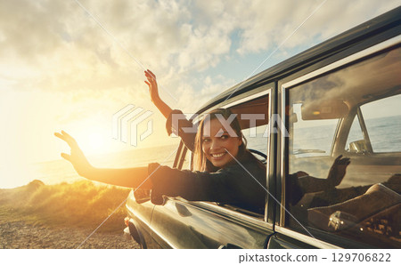 Car, woman and road trip to the beach, vacation and summer break, travelling and happiness. Young female smile, girl and vehicle for seaside holiday, fun and freedom with sunset, journey or adventure 129706822