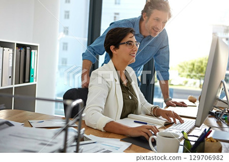Corporate, man and woman with computer, talking and online reading for strategy, marketing and modern office. Manager, coworkers or female employee with digital advertising, explain system or process 129706982