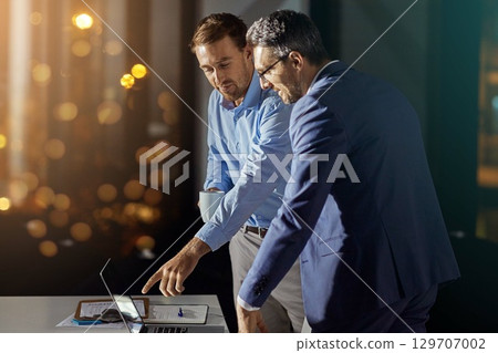 Teamwork, reading and night with business people at laptop for project management, planning or web design. Collaboration, goal and documents with employee in digital agency for marketing strategy 129707002