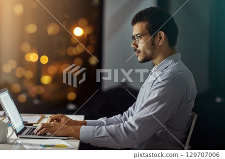 Businessman, laptop and typing in research, analysis or web design on work desk at office. Employee man sitting and working on computer in overtime at night for dedication to meet project deadline Businessman, laptop and typing in research, analysis or web design on work desk at office. Employee man sitting and working on computer in overtime at night for dedication to meet project deadline 129707006