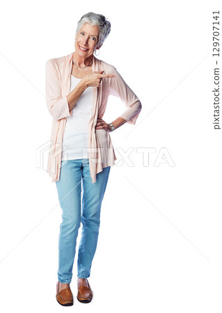 Senior woman, happy portrait and pointing finger, standing isolated in white background for advertising or marketing mockup. Elderly female, smile and point finger for branding or product placement 129707141