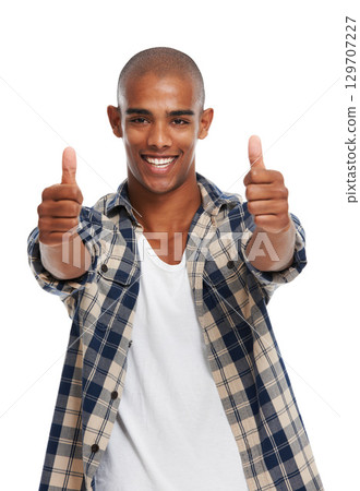 Portrait, thumbs up and motivation with a black man in studio on a white background saying yes or thank you. Winner, face and success with a handsome young male posing for a deal or agreement 129707227