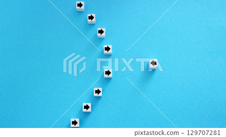 Resistance or individuality. Line of arrows in one direction and one in opposite. 129707281