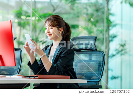 Business woman calling in the office Business woman calling in the office 129707392