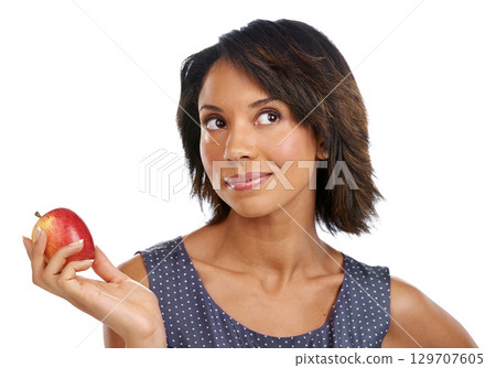 Fruit, thinking or black woman eating an apple in studio on white background with marketing mockup space. Choices, ideas or thoughtful African girl advertising a healthy natural diet for wellness 129707605