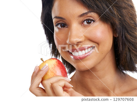 Portrait, fruit or happy black woman eating an apple in studio on white background with marketing mockup space. Smile, face or African girl advertising healthy food or diet for nutrition for wellness Portrait, fruit or happy black woman eating an apple in studio on white background with marketing mockup space. Smile, face or African girl advertising healthy food or diet for nutrition for wellness 129707608