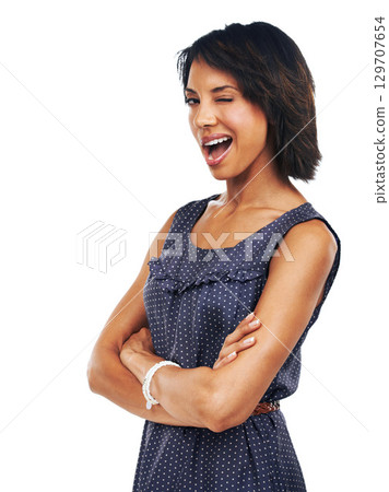Arms crossed, pride and portrait of a black woman wink on a white background in studio. Flirty, seductive and girl with arms folded with confidence, happiness and enthusiasm on a studio background 129707654