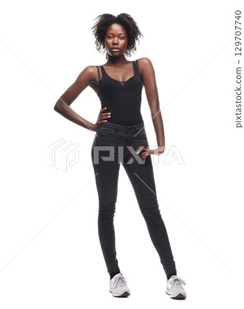 Fashion, portrait and African girl model in a studio with a casual outfit, confidence and natural pose. Beauty, young and proud black woman with an afro posing while isolated by a white background. Fashion, portrait and African girl model in a studio with a casual outfit, confidence and natural pose. Beauty, young and proud black woman with an afro posing while isolated by a white background. 129707740