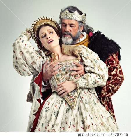 Theater, king and queen in costume with violence in in crown and renaissance clothes in studio. Art, cosplay and larp, couple in medieval play, royal history character and woman in distress with man. Theater, king and queen in costume with violence in in crown and renaissance clothes in studio. Art, cosplay and larp, couple in medieval play, royal history character and woman in distress with man. 129707926