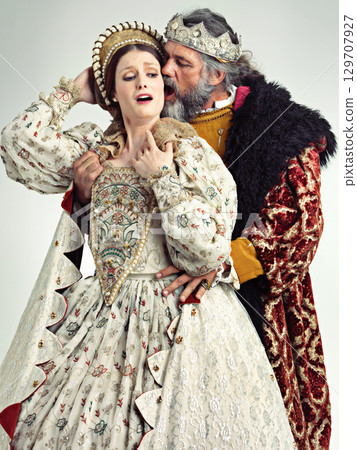 Medieval king, queen and violence in studio for drama, danger and together with renaissance clothes. Ancient royal couple, surprise and shock with distress, crying and actor with vintage fashion 129707927