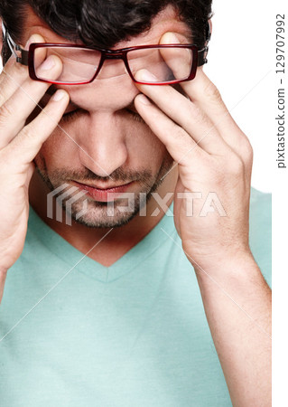 Mental health, depression and face of studio man with anxiety problem, burnout fatigue and depressed over mistake. Medical healthcare crisis, headache and sad model with migraine on white background 129707992