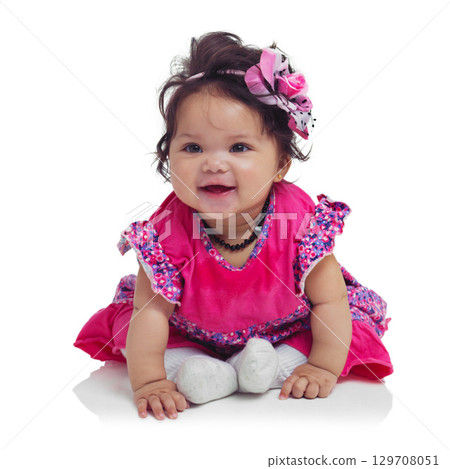Innocent, cute and happy baby girl in a studio with a floral, beautiful and flower outfit and headband. Happiness, smile and infant child sitting and playing while isolated by a white background. Innocent, cute and happy baby girl in a studio with a floral, beautiful and flower outfit and headband. Happiness, smile and infant child sitting and playing while isolated by a white background. 129708051