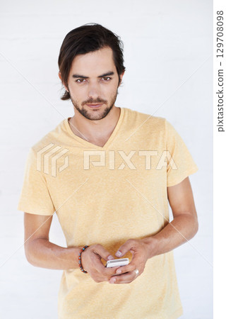 Young man, portrait with smartphone, social media and chat with communication, technology isolated on white background. Network, internet and phone for social network or gaming, tech and online Young man, portrait with smartphone, social media and chat with communication, technology isolated on white background. Network, internet and phone for social network or gaming, tech and online 129708098