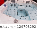 Modern hot tub with bubbling water and jets, showcasing relaxation and luxury features 129708292