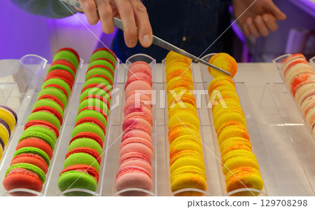 Colorful macarons displayed in a pastry shop with vibrant hues and tempting textures for dessert lovers 129708298