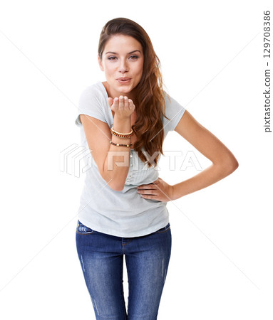 Blowing kiss, flirting and portrait of a woman with a smile for motivation, empowerment and care. Happiness, friendly and model with love, flirty body language and fun on a white background in studio 129708386