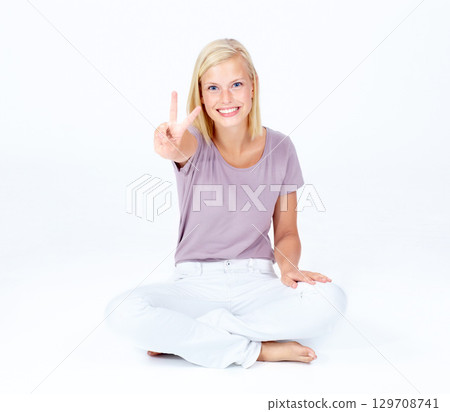 Happy woman, portrait or peace sign for good luck, positive energy or sitting optimism on white studio background. Smile, model or cool hand gesture for playful, fun or comic expression on backdrop 129708741