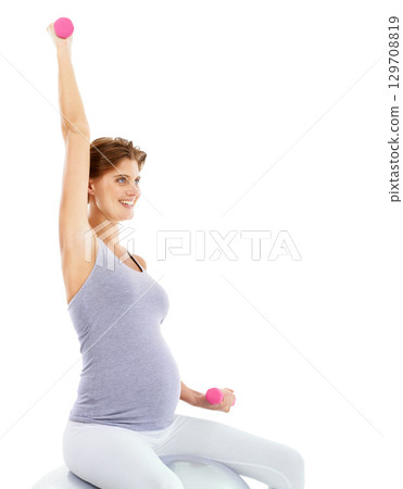 Exercise, weightlifting and pregnant woman on gym ball for maternity wellness, healthy lifestyle and wellbeing. Sports, pregnancy and female for workout, training and pilates with dumbbells in studio 129708819