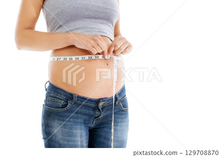 Pregnant, measuring tape and stomach in studio as woman check growth, development and health on mockup. Abdomen, wellness and pregnant woman self care, diet and healthy progress on white background 129708870