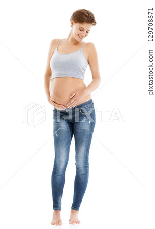 Body of a pregnant woman in studio on a white background happy with pregnancy health, growth and development. Healthcare, wellness and an excited mother, hand holding stomach with advertising mockup 129708871