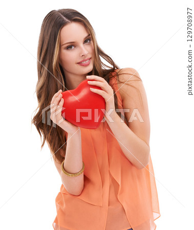 Portrait, heart and love with a woman in studio on a white background holding an emoji, icon or shape. Red, romantic and valentines day with a young female holding a symbol or romance in her hands 129708977