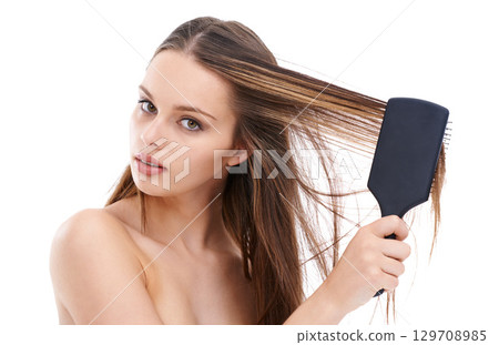 Beautiful, young and woman brushing hair for self love and self care or hygiene against a white studio background. Portrait of isolated attractive female using brush for haircare or hair treatment 129708985