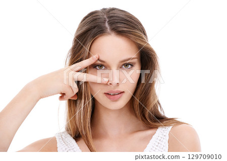 Portrait, hand and eyes with a model woman in studio on a white background with her fingers on her face. Microblading, eyecare and beauty with an attractive young female posing to promote cosmetics Portrait, hand and eyes with a model woman in studio on a white background with her fingers on her face. Microblading, eyecare and beauty with an attractive young female posing to promote cosmetics 129709010