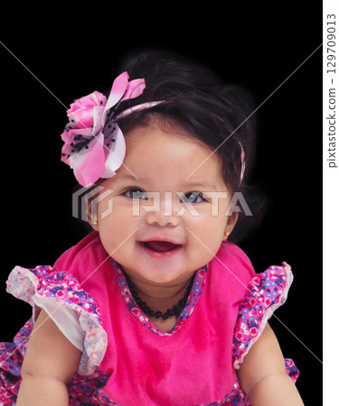 Portrait, baby and girl with a newborn infant in studio on a black background in floral clothes. Kids, flower and development with a female child on dark space for cute or adorable product placement Portrait, baby and girl with a newborn infant in studio on a black background in floral clothes. Kids, flower and development with a female child on dark space for cute or adorable product placement 129709013