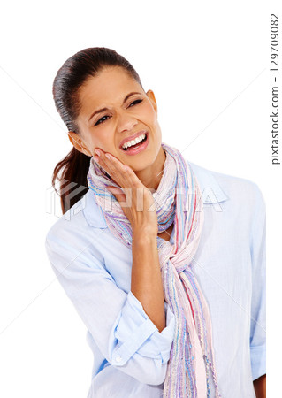 Dental, toothache and oral hygiene with a black woman in studio isolated on a white background at the dentist. Teeth, gums and cavity with a female holding her jaw on blank space from tooth decay 129709082