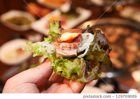 Korean bbq. ssam : eat pork wrapped in lettuce leaves 129709089