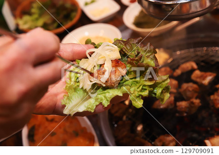 Korean bbq. ssam : eat pork wrapped in lettuce leaves Korean bbq. ssam : eat pork wrapped in lettuce leaves 129709091