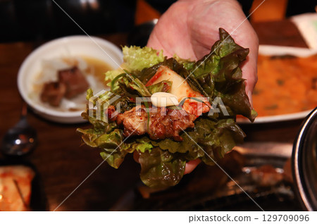 Korean bbq. ssam : eat pork wrapped in lettuce leaves Korean bbq. ssam : eat pork wrapped in lettuce leaves 129709096